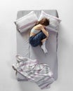 Scare. Top view portrait of young girl wearing homewear, pajamas sleeping in big gray bed. Concept of health, home Royalty Free Stock Photo