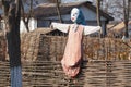 Scarecrow garden on a wicker fence.