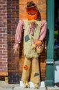 Pumpkin Scarecrow Against Building Holding Basket Royalty Free Stock Photo