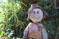 Scarecrow sitting in the autumn garden Royalty Free Stock Photo