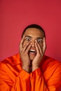 scared african american man in orange Royalty Free Stock Photo