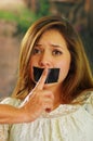 Scared beautiful young woman being silenced with tape on her mouth