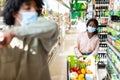 Scared Black Woman Looking At Sick Guy Coughing In Supermarket Royalty Free Stock Photo