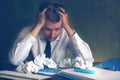 Scared business man looking on crumpled office paper.