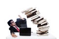 Scared businessman with pile of books