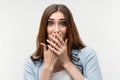 Scared caucasian girl covering mouth with hands. Keep silence concept Royalty Free Stock Photo