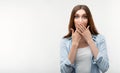 Scared girl is covering mouth with hands on white background. Keep silence concept Royalty Free Stock Photo