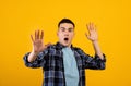 Scared Caucasian guy shouting in panic, making STOP gesture with both hands over orange studio background Royalty Free Stock Photo