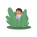 Scared child in glasses hiding behind green bush and peeping, vector cartoon boy playing hide and seek game kid activity