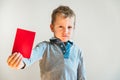 Scared child with red anti bullying card