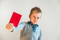 Scared child with red anti bullying card