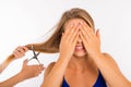 Scared disappointed woman going to cut her split ends Royalty Free Stock Photo