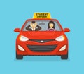 Scared driving school instructor sitting in car next to a female student driver. Woman driving a red car. Royalty Free Stock Photo