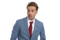 Scared elegant guy in blue suit looking to side and feeling fear Royalty Free Stock Photo