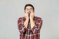 Scared emotional surprised male model isolated over gray background