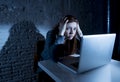 Scared female teenager with computer laptop suffering cyberbullying and harassment being online abused Royalty Free Stock Photo