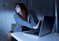 Scared female teenager with computer laptop suffering cyberbullying and harassment being online abused Royalty Free Stock Photo