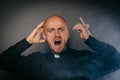 Scared frightened catholic priest in black shir