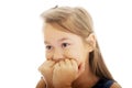 Scared girl biting her nails Royalty Free Stock Photo