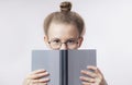Scared girl hiding behind the book Royalty Free Stock Photo