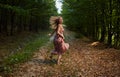 Scared girl running through forest Royalty Free Stock Photo