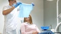 Scared girl treats teeth in a modern clinic. Cowardice and fear of the dentist.