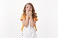 Scared innosent timid little girl with blond hair and blue eyes, panic, standing alone white background, biting fingers