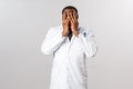Scared, insecure and shocked african-american male doctor, physician cant look at severe trauma of patient, close eyes