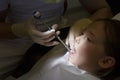 Scared little girl at dentist office, getting local anesthesia injection into gums, dentist numbing gums for dental work