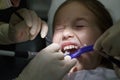 Scared little girl at the dentists office, in pain during a treatment Royalty Free Stock Photo