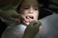 Scared little girl at the dentists office, in pain during a treatment Royalty Free Stock Photo