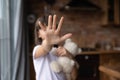 Scared little girl making no sign, showing hand stop gesture Royalty Free Stock Photo