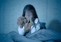 Scared little girl covering face with hands in fear in darkness at night Royalty Free Stock Photo