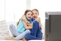 Scared little girls watching horror on tv at home Royalty Free Stock Photo