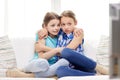 Scared little girls watching horror on tv at home Royalty Free Stock Photo