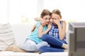 Scared little girls watching horror on tv at home Royalty Free Stock Photo