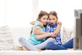 Scared little girls watching horror on tv at home Royalty Free Stock Photo