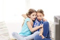 Scared little girls watching horror on tv at home Royalty Free Stock Photo