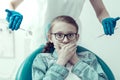 Scared little patient closing her mouth with two hands Royalty Free Stock Photo