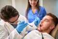 Scared patient at dentist repairing tooth