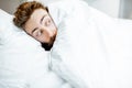 Scared man hiding under the bedsheets Royalty Free Stock Photo