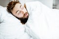 Scared man hiding under the bedsheets Royalty Free Stock Photo