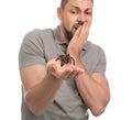 Scared man holding tarantula on background. Arachnophobia fear of spiders Royalty Free Stock Photo