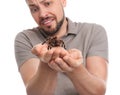 Scared man holding tarantula on background. Arachnophobia fear of spiders Royalty Free Stock Photo