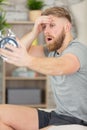 scared man at home looking at clock being late Royalty Free Stock Photo