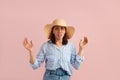 Scared nervous woman with dark hair is afraid of something, keeps mouth open and palms raised, looks at camera, wears Royalty Free Stock Photo