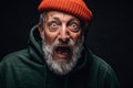 Scared shocked bearded old man stares at camera with open mouth, bugged eyes. Royalty Free Stock Photo
