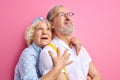 scared or shocked elderly woman stand in shock hugging man from back Royalty Free Stock Photo