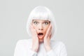 Scared shocked woman with opened mouth and hands on cheeks Royalty Free Stock Photo