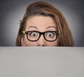 Scared surprised woman peeking over edge of blank billboard Royalty Free Stock Photo